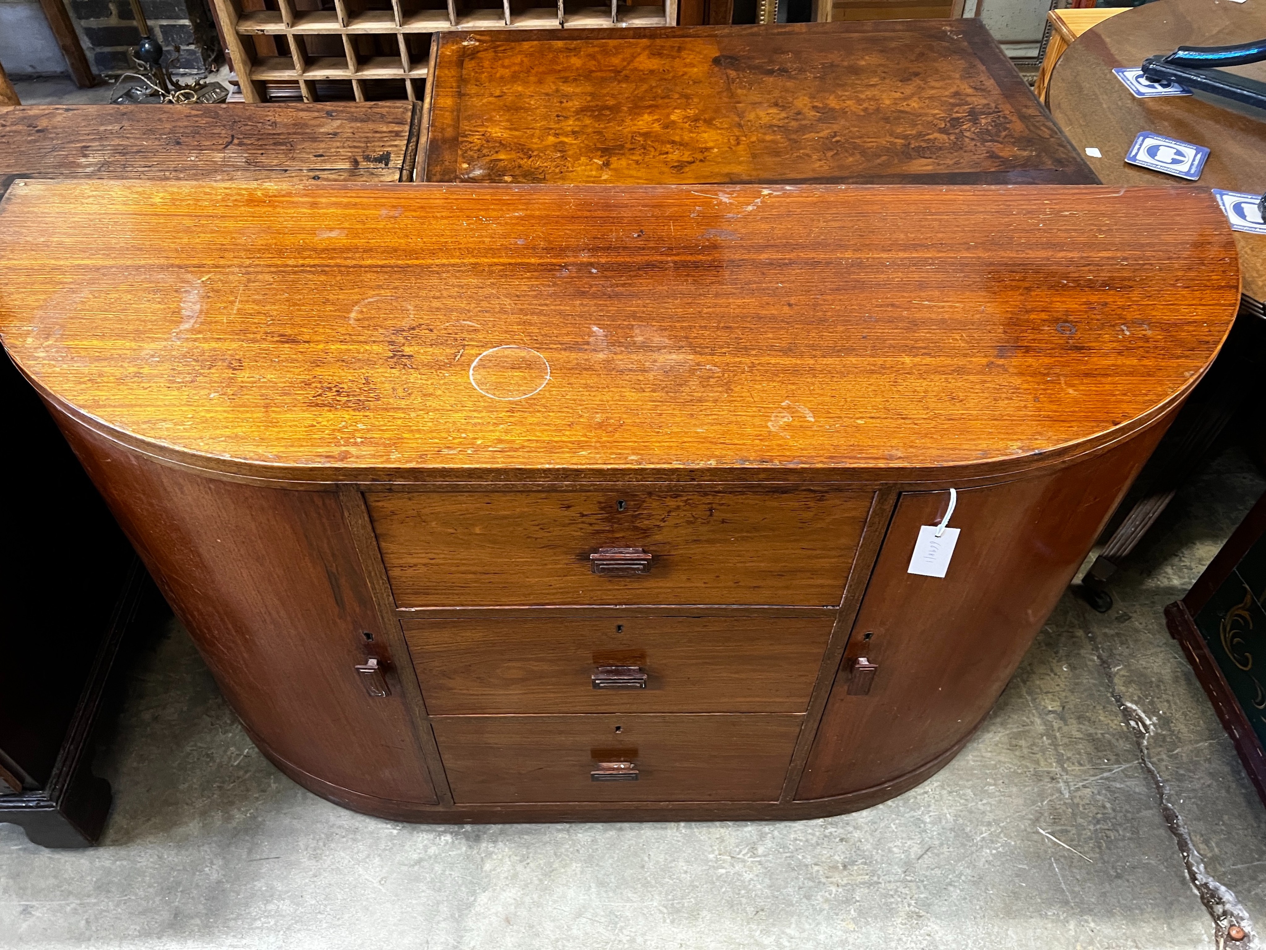 A Betty Joel Token furniture D shaped sideboard, the interior label dated January 1935, width 142cm, depth 46cm, height 82cm